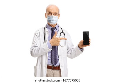 Elderly Male Doctor With A Medical Face Mask Showing A Mobile Phone Isolated On White Background