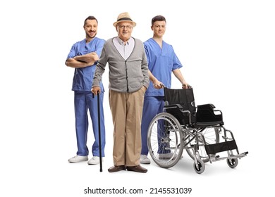 Elderly Male Patient And Two Health Care Workers With A Wheelchair Isolated On White Background