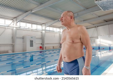 An elderly man is actively engaged in swimming and sports in the pool in a retired sports complex
