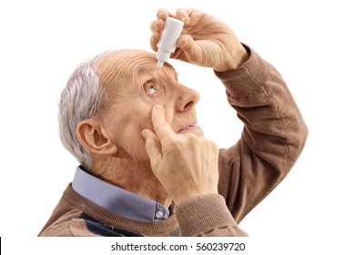 Elderly Man Applying Eye Drops Isolated On White Background