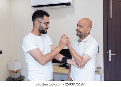 Elderly Man with Arm Injury in Home Therapy Session - Powered by Shutterstock