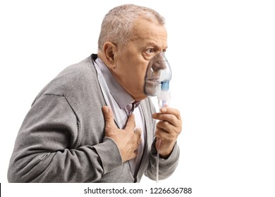 Elderly Man With Asthma Using An Inhaler And Holding His Chest Isolated On White Background

