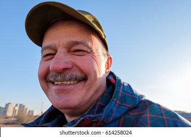 An Elderly Man In  Baseball Cap Looks  And Smiles. Positive Mood For A Walk