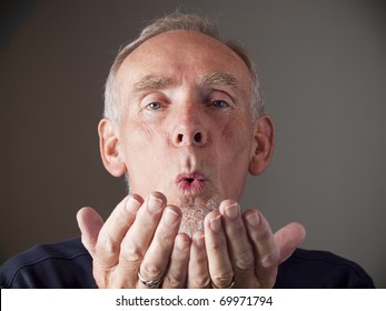Elderly Man Blowing A Kiss