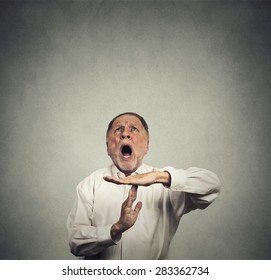 Elderly Man Boss Showing Time Out Hand Gesture, Frustrated Screaming To Stop Looking Up Isolated On Grey Wall Background. Too Many Things To Do. Human Emotions Face Expression Reaction