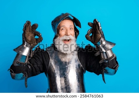 Elderly man cheerfully posing in medieval knight armor with expressive gestures and vibrant blue background