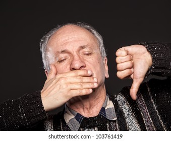 An Elderly Man With Closed Eyes Closes Her Mouth And Shows Thumb Down