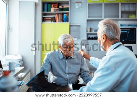 Elderly man discussing health results with doctor in clinic office