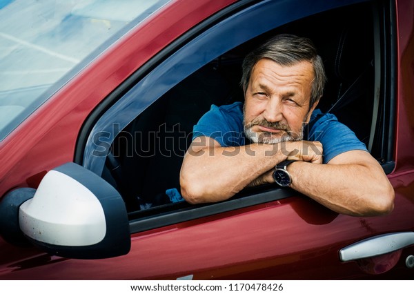 elderly man driver in his\
car