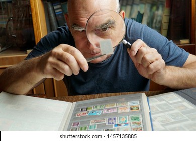  An elderly man examines a brand through a magnifying glass.                               - Powered by Shutterstock