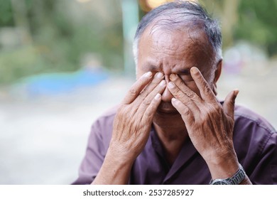 elderly man expresses deep emotion while covering his face with his hands. - Powered by Shutterstock