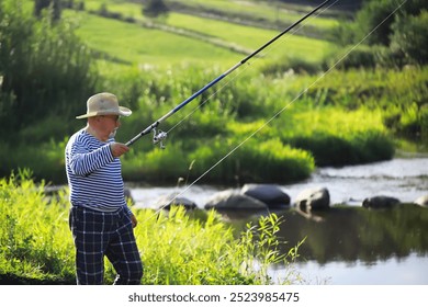 Elderly Man Fishing by Riverside in Summer - Nature, Water, Outdoors, Leisure, Tranquil - Powered by Shutterstock