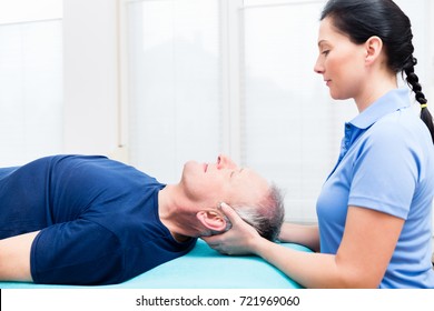 Elderly man getting massage from physio - Powered by Shutterstock