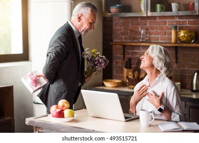 Elderly man giving flowers to his dear wife - Powered by Shutterstock