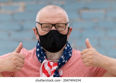 An Elderly Man With A Gray Beard And Glasses Tied An American Flag Bandana And A Black Mask. He's Overflowing With Emotion 