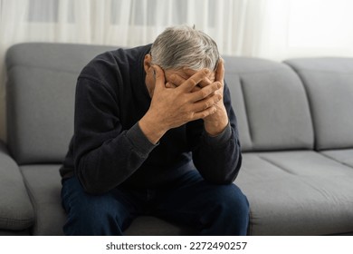 Elderly man with hand on his temple has a headache - Powered by Shutterstock