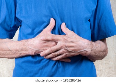 Elderly Man Hands Holding Stomach, Suffering From Stomachache. White Background