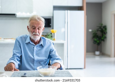 An elderly man has anorexia. Can't eat rice in the morning of the day - Shutterstock ID 2169331703