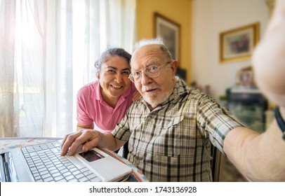 Elderly Man With Her Caregiver Taking A Selfie Photo At Home