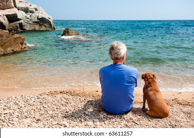 Elderly Man With His Dog At The Summer Beach