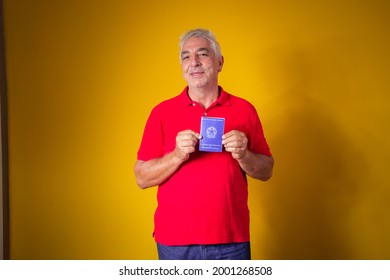 Elderly Man Holding A Brazilian Work Card