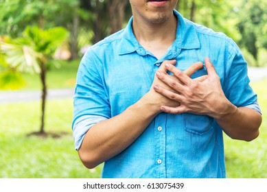 Elderly Man Holding Hands On Chest Suffering From Heart Attack, Closeup