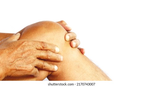 An elderly man holds hands and massages on his knees while feeling pain when walking, working for a long time, white background.
