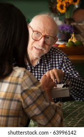 Elderly Man In Home With Care Provider Or Survey Taker In Kitchen