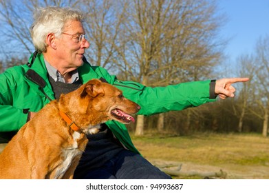 Elderly Man Hunting With Dog In Nature