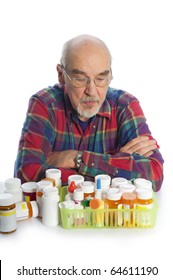 Elderly Man Looking At Prescription Bottles