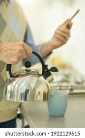 Elderly Man Making Tea While Video-calling Someone