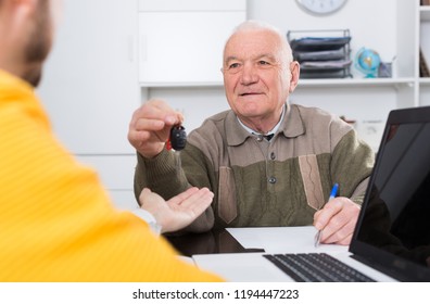 Elderly Man And Manager Signed Car Purchase Contract At Office And Hand Over Keys