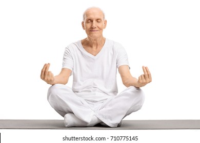 Elderly Man Meditating On An Exercise Mat Isolated On White Background