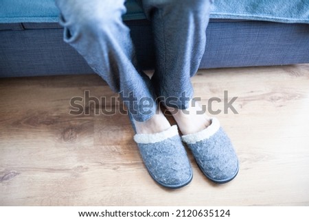 Elderly man old man got out of bed and dressed slippers home. Selective focus