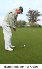 elderly man on the golf putting green