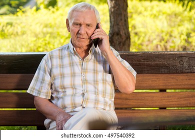 Elderly Man On The Phone. Old Male On Park Bench. I Miss Family And Friends. Just Wanted To Say Hi.