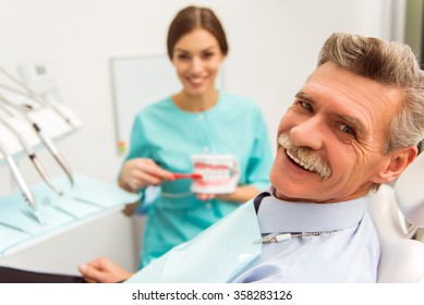 Elderly man on a review of a dentist, sitting in a chair - Powered by Shutterstock