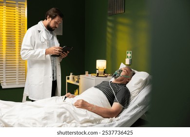 An elderly man with an oxygen mask on his face lies in bed. A young doctor checks the patient's vital signs and test results on a tablet. - Powered by Shutterstock