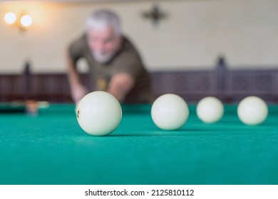  An Elderly Man Plays Billiards. Selective Focus