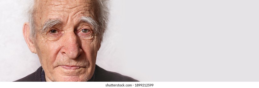 Elderly Man Portrait. Close Up. Glaucoma In Left Eye. Getting Old Concept. Gray Eyebrows And Hair. Amazingly Beautiful Old Man. Kindness In His Eyes. Retired. 