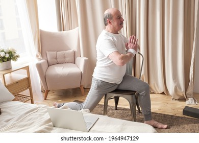 Elderly Man Practicing Yoga Asana Warrior Using Chair