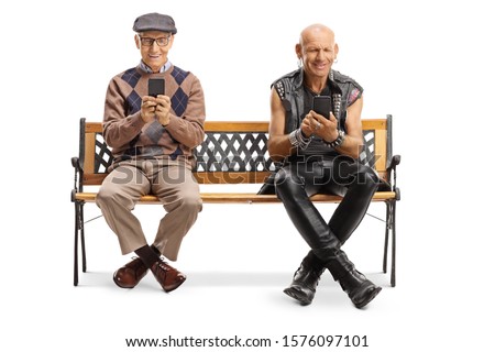 Elderly man and a punker using mobile phones and sitting on a bench isolated on white background