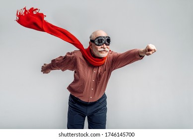 Elderly Man In A Red Scarf And Pilot Glasses