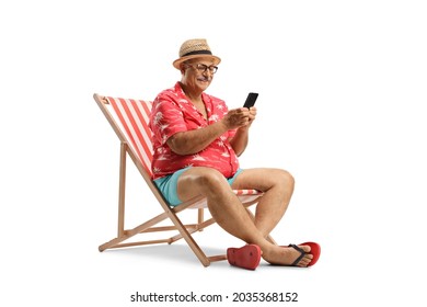 Elderly man relaxing in a beach chair and using a smartphone isolated on white background