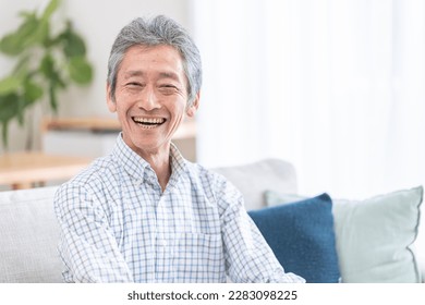 Elderly man relaxing in the room - Powered by Shutterstock