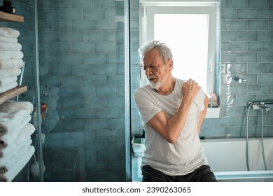 Elderly man with shoulder pain in bathroom - Powered by Shutterstock