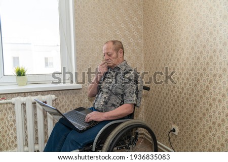 Similar – Senior woman in a wheelchair alone