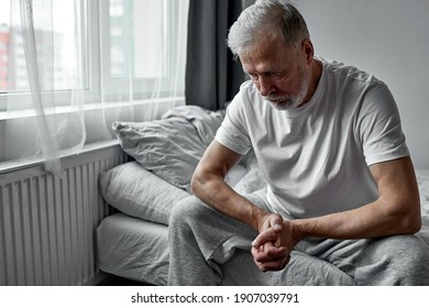 Elderly Man Sitting Alone At Home, Social Distancing And Self Isolation In Quarantine Lockdown For Coronavirus