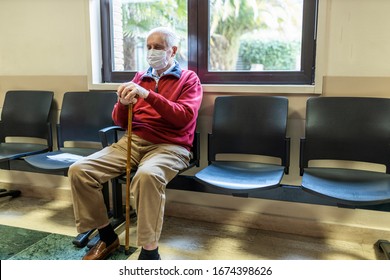 Elderly Man Sitting In Doctor's Office In A Hospital With Respirator