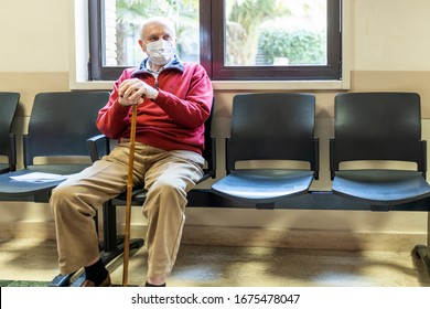 Elderly Man Sitting In Doctor's Office In A Hospital With Respirator